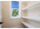 Pantry with a window and open shelving provides extra storage at 1413 Bayshore Blvd # 11, Dunedin, FL 34698