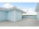 Wide-angle view of a rooftop deck with light blue siding and concrete floors at 1413 Bayshore Blvd # 11, Dunedin, FL 34698