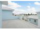 Rooftop deck with blue siding and white railings offering neighborhood views at 1413 Bayshore Blvd # 11, Dunedin, FL 34698