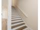Staircase with wood treads and white risers leading to the second floor at 1413 Bayshore Blvd # 11, Dunedin, FL 34698