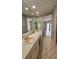 Bathroom with dual sinks, large mirror, shower and views of the lanai at 16502 Windsor Park Dr, Lutz, FL 33549