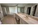 Bathroom with dual sinks, large mirror, shower and garden tub at 16502 Windsor Park Dr, Lutz, FL 33549
