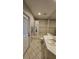 Well-maintained bathroom featuring a vanity, tiled floor, bathtub, and showerhead in a clean, functional layout at 16502 Windsor Park Dr, Lutz, FL 33549