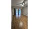 Bedroom with wood-look floors, ceiling fan, and sliding glass doors to the lanai at 16502 Windsor Park Dr, Lutz, FL 33549