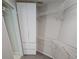 Walk-in closet with built-in shelving and neutral paint at 16502 Windsor Park Dr, Lutz, FL 33549