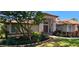 Inviting single-story home with mature landscaping and a charming red door at 16502 Windsor Park Dr, Lutz, FL 33549