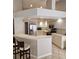 Bright kitchen featuring stainless appliances, breakfast bar and light wood cabinetry at 16502 Windsor Park Dr, Lutz, FL 33549