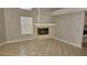 Bright living room features neutral paint, tile floors and a fireplace at 16502 Windsor Park Dr, Lutz, FL 33549