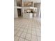 Spacious open-concept living area with tile floors flowing into the modern kitchen at 16502 Windsor Park Dr, Lutz, FL 33549