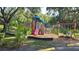 A colorful playground featuring a slide, climbing structures, and swing set for to enjoy outdoor activities at 16502 Windsor Park Dr, Lutz, FL 33549