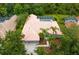 Aerial view of a house with mature landscaping and a private backyard oasis at 17818 Arbor Greene Dr, Tampa, FL 33647