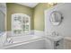 Bathroom with soaking tub and pedestal sink at 17818 Arbor Greene Dr, Tampa, FL 33647