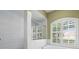 Shower and tub in the bathroom with shuttered window at 17818 Arbor Greene Dr, Tampa, FL 33647