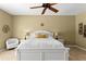 Bedroom with plush bed, ceiling fan, and decorative wall art at 17818 Arbor Greene Dr, Tampa, FL 33647