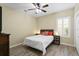 Bedroom features a ceiling fan, a large window with shutters, and a woven headboard at 17818 Arbor Greene Dr, Tampa, FL 33647