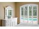 Bedroom with white dresser and window overlooking the pool at 17818 Arbor Greene Dr, Tampa, FL 33647