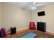 Bedroom features a ceiling fan, a large window, a yoga mat, and a red leather chair at 17818 Arbor Greene Dr, Tampa, FL 33647