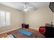 Bedroom features a ceiling fan, a large window, a yoga mat, and a red leather chair at 17818 Arbor Greene Dr, Tampa, FL 33647