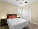 Bedroom features a ceiling fan, a large window with shutters, and a woven headboard at 17818 Arbor Greene Dr, Tampa, FL 33647