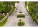 Entrance to the Enclave features manicured landscaping, a paved roundabout, and decorative signage at 17818 Arbor Greene Dr, Tampa, FL 33647