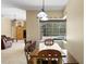 Bright dining room with a wood table, bench seating, and view of the pool at 17818 Arbor Greene Dr, Tampa, FL 33647