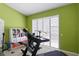 Bright exercise room featuring a treadmill, shelving, and plantation shutters for privacy at 17818 Arbor Greene Dr, Tampa, FL 33647