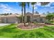 Charming home featuring lush landscaping, mature palm trees, and a tile roof at 17818 Arbor Greene Dr, Tampa, FL 33647
