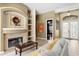 Inviting living room featuring a fireplace and views of the foyer and front door at 17818 Arbor Greene Dr, Tampa, FL 33647