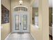 Inviting foyer with tile flooring, a decorative front door, and neutral paint at 17818 Arbor Greene Dr, Tampa, FL 33647