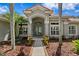 Beautiful entryway with a decorative glass front door and manicured landscaping at 17818 Arbor Greene Dr, Tampa, FL 33647