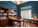 Traditional home office boasts hardwood floors, wood furniture, and a window with plantation shutters at 17818 Arbor Greene Dr, Tampa, FL 33647