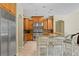 Gourmet kitchen with stainless steel appliances, granite countertops, and wooden cabinets at 17818 Arbor Greene Dr, Tampa, FL 33647