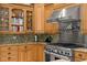 Modern kitchen with stainless steel range hood and custom wood cabinetry at 17818 Arbor Greene Dr, Tampa, FL 33647