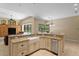Open-concept kitchen featuring granite counters, stainless steel appliances and pool views at 17818 Arbor Greene Dr, Tampa, FL 33647