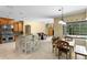 Open kitchen with stainless steel appliances, granite countertops and adjacent dining area overlooking pool at 17818 Arbor Greene Dr, Tampa, FL 33647