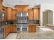 Gourmet kitchen with stainless steel range, granite countertops, and custom cabinets at 17818 Arbor Greene Dr, Tampa, FL 33647