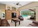 Well-lit living room that features a stylish built-in cabinet and access to the swimming pool at 17818 Arbor Greene Dr, Tampa, FL 33647