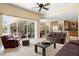 Spacious living room with tile floors and views of the outdoor seating area and kitchen at 17818 Arbor Greene Dr, Tampa, FL 33647