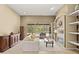 Cozy living room featuring a fireplace, built-in shelves, and access to the screened lanai at 17818 Arbor Greene Dr, Tampa, FL 33647