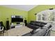 Living room features a vaulted ceiling, a large window with shutters, and comfortable furniture at 17818 Arbor Greene Dr, Tampa, FL 33647