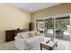 Comfortable living room with sliding glass doors leading to a screened lanai and pool area at 17818 Arbor Greene Dr, Tampa, FL 33647