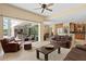 Open living room with sliding glass doors to a patio and views into the kitchen and dining spaces at 17818 Arbor Greene Dr, Tampa, FL 33647