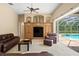 Living room with a custom cabinet and direct access to the pool area through a sliding glass door at 17818 Arbor Greene Dr, Tampa, FL 33647