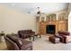 Comfortable living room featuring a custom built-in entertainment center and tile flooring at 17818 Arbor Greene Dr, Tampa, FL 33647