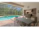 Spacious covered outdoor kitchen and dining area with built in BBQ, perfect for entertaining at 17818 Arbor Greene Dr, Tampa, FL 33647