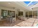 Covered patio featuring brick flooring, ceiling fan, and comfortable seating, perfect for outdoor relaxation at 17818 Arbor Greene Dr, Tampa, FL 33647