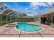 Enclosed pool area with a hot tub and patio with access to home's outdoor kitchen at 17818 Arbor Greene Dr, Tampa, FL 33647