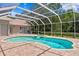 Enclosed pool area complete with a hot tub, brick patio, and screened enclosure at 17818 Arbor Greene Dr, Tampa, FL 33647