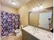 Full bathroom including vanity and geometric shower curtain at 17942 Villa Creek Dr # 17942, Tampa, FL 33647