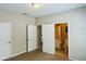 Bedroom with two doors, one leading to bathroom with tile flooring and cream color painted walls at 17942 Villa Creek Dr # 17942, Tampa, FL 33647